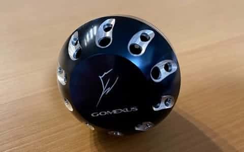 Black fishing reel part with logo