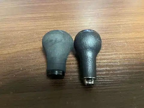 Two fishing reel handles side by side