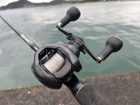 Fishing reel mounted on rod outdoors