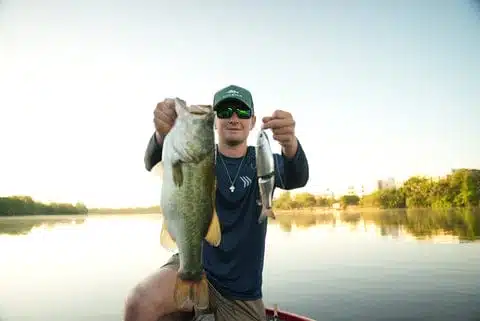 The World's First CNC Metal Glidebait 4 Angler holding bass and fishing lure