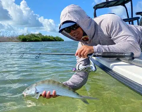 Bass Fishing Tips: How to Catch Bass 3 a man holding a fish in a boat