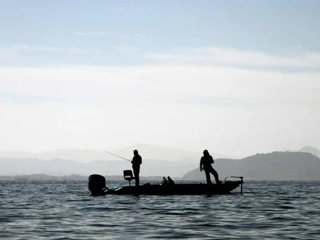 Angler performing finesse bass fishing technique with a lightweight spinning tackle setup