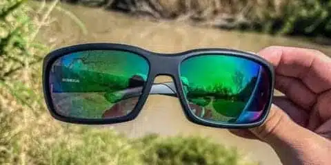 Sunglasses with green reflective lenses.