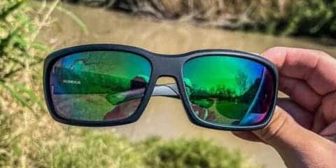 Sunglasses with green reflective lenses.