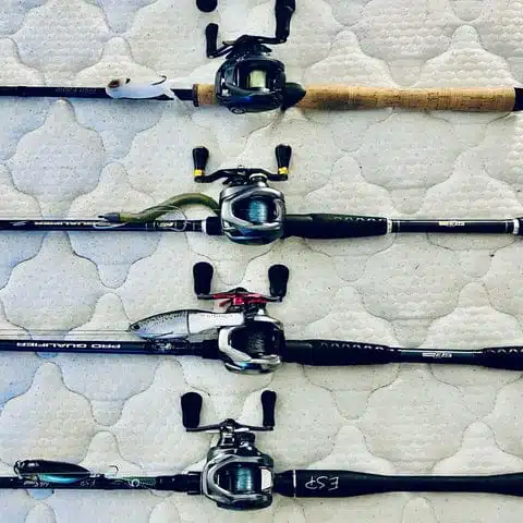 Four fishing rods with reels displayed.