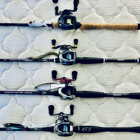 Four fishing rods with reels displayed.