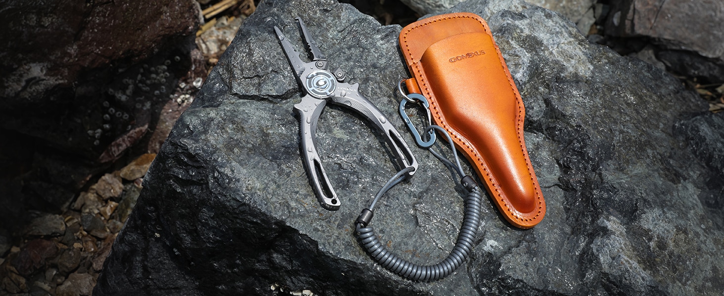 Pliers with leather sheath on rock.