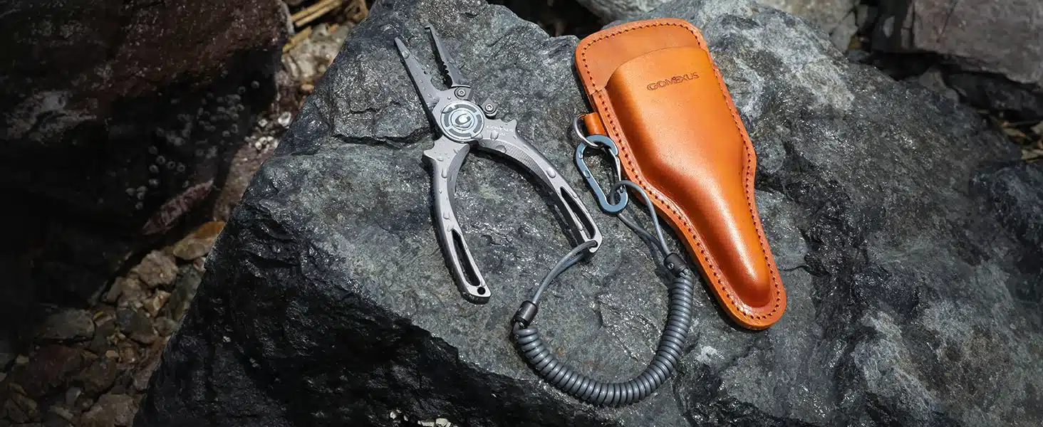 Pliers with leather sheath on rock.